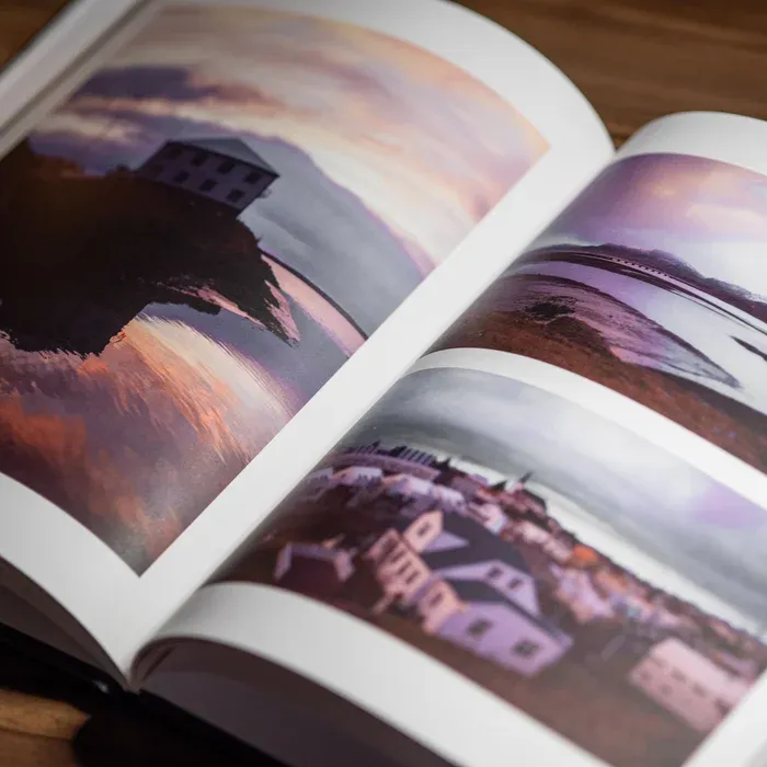 A close up shot of two pages from Greg Lehming's photo book Iceland showing three photos of the Icelandic landscape