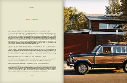 Paragraphs on the left hand page, a car with wood paneling and a surfboard on top parked in front of a house on the other page.
