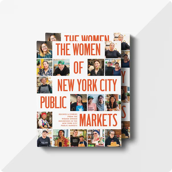 Two copies of the photo book 'The Women of New York City Public Markets', with multiple portrait photos on the front cover
