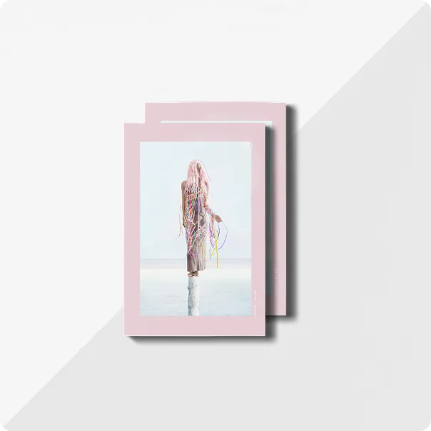 Two copies of 'Rising Waters' a photo narrative by Alice de Krujis featuring abstract portrait photography on the front cover