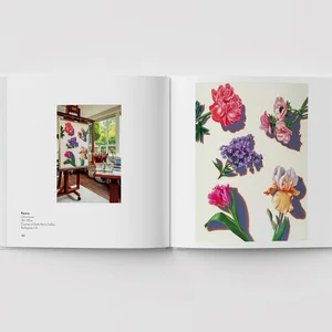 An open photo book showing two pages - the left page shows a canvas painted with flowers in a living room while the right page shows a painting of flowers on a white background.