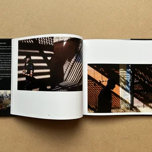 Giancarlo Zuccarone and F. Prina’s photo book MAROC mon amour open on two dark photos of shadows against walls