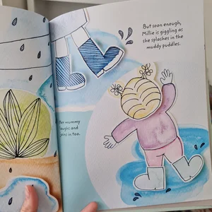 Stevie Russell’s children's book, How to Find a Monkey, open on a page of illustrations and text about splashing in puddles