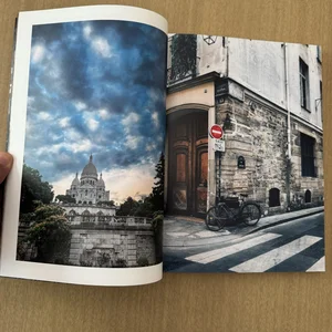 Jimmy Fikes’ photo zine, Travel Job, open on two travel photos of a city street corner and an old building with three domes