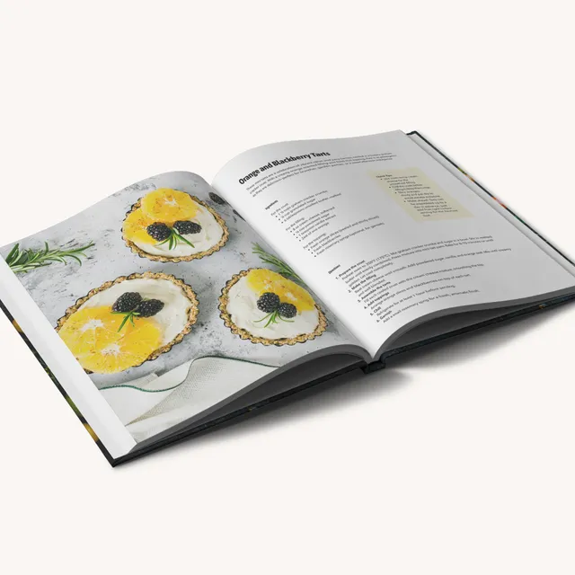 Open imagewrap hardcover cookbook showing recipe pages with food photography and ingredient instructions.