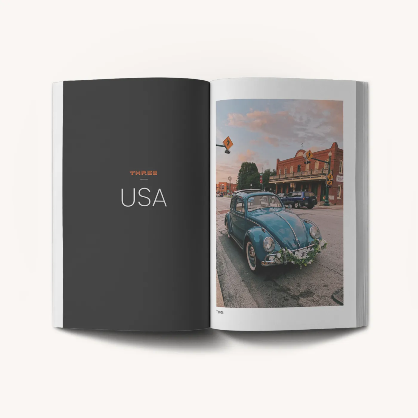Paperback travel book open showing 'USA' chapter with vintage car photograph and destination content.