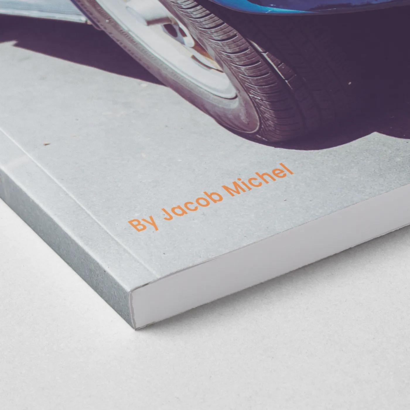 Paperback book shown close up and closed with minimalist typography and orange accent text on the cover.