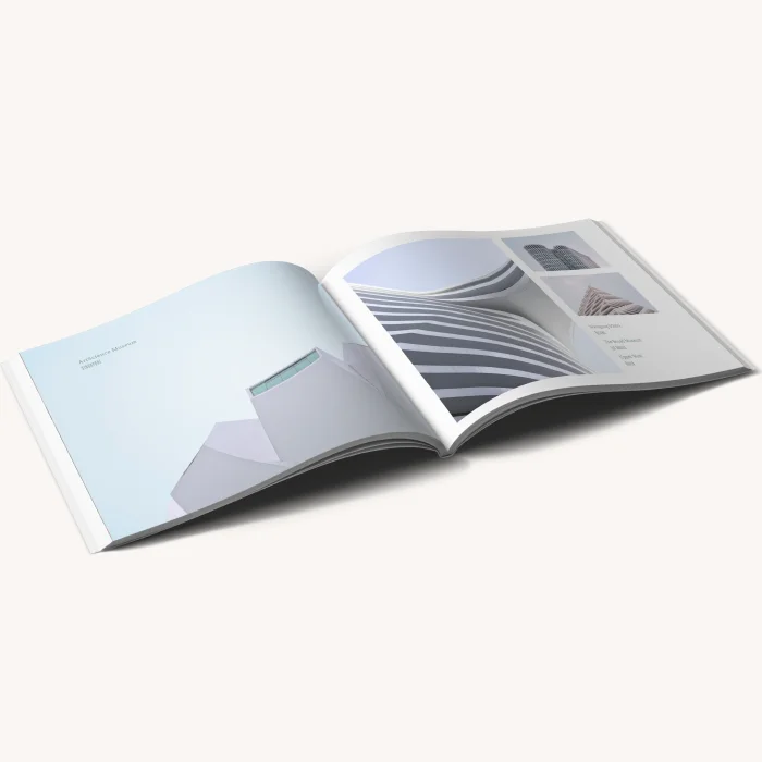 Open softcover photo book showing a clean, minimalist layout in a light blue color scheme.