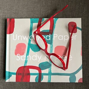 A colorful photo book showing abstract geometric art with red and curved shapes and colorful elements on the cover.