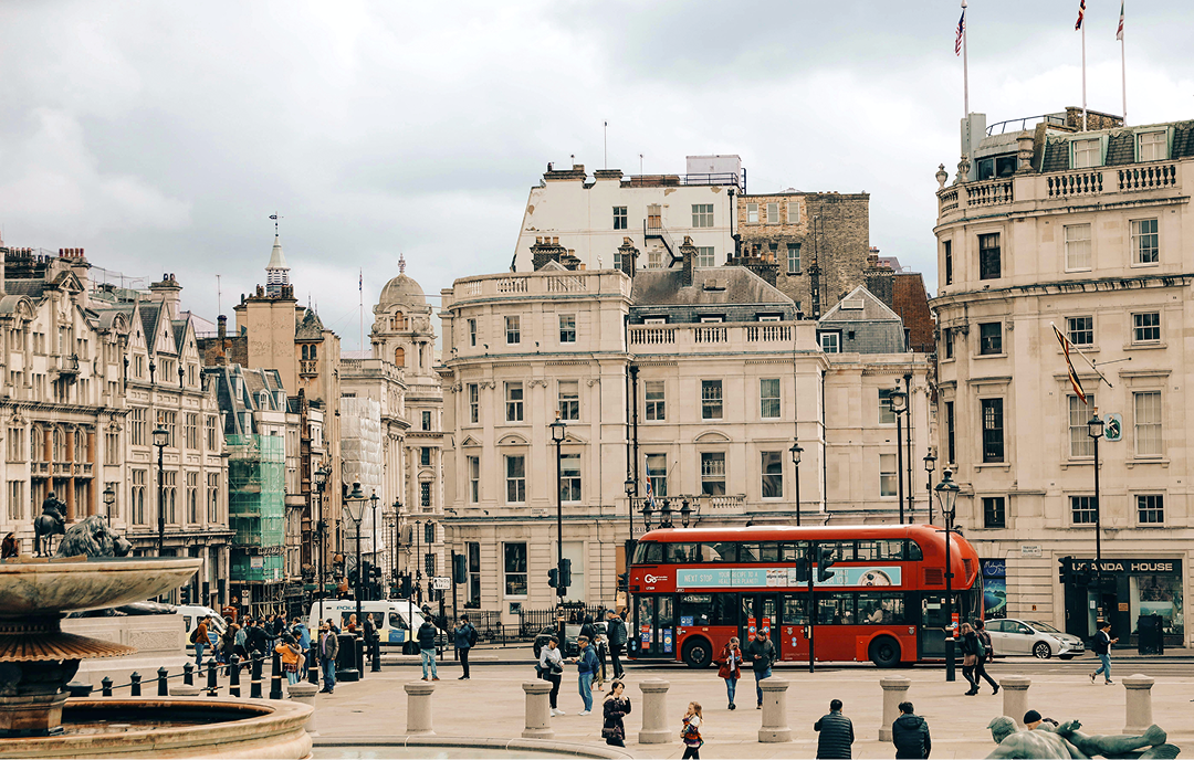 London Photowalk Event (3/11/25) – A scenic view of Trafalgar Square with a red double-decker bus.