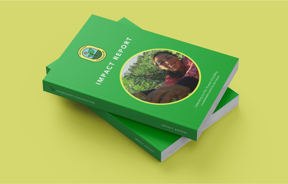 Two trade books stacked on top of one another titled Impact Report with a green cover and an image of a person holding a tree branch.